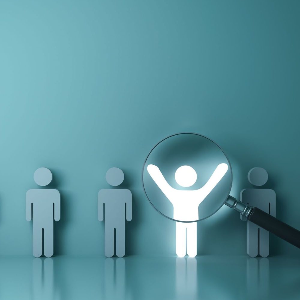 Searching for the right person concept, Stand out from the crowd and different concept , Magnifying glass focusing on the light man standing with arms wide open on green wall background. 3D rendering.